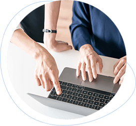 two people working with a MacBook