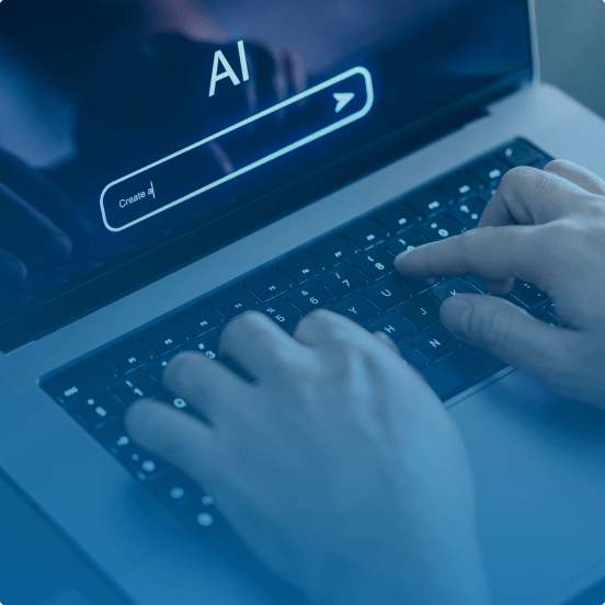 Close-up of a person typing on a laptop with an AI-powered search bar on the screen