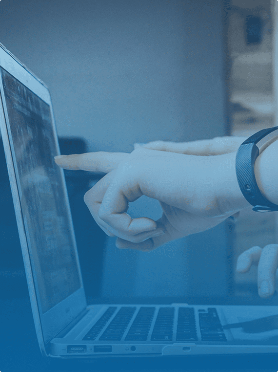 finger pointing at laptop