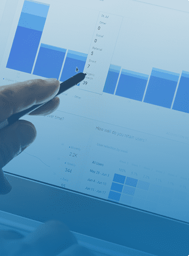 hand holding pen against charts