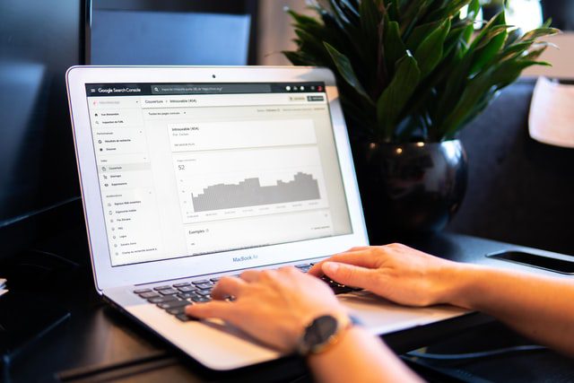 A man using a laptop on a black table