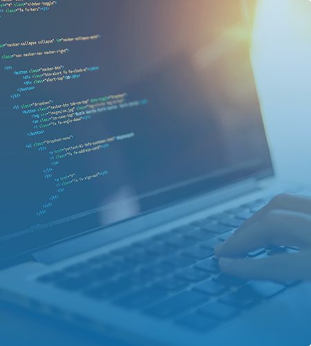 a developer performing web design work on a black and silver laptop