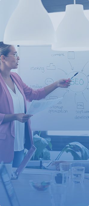 a woman looking at a whiteboard with information about SEO