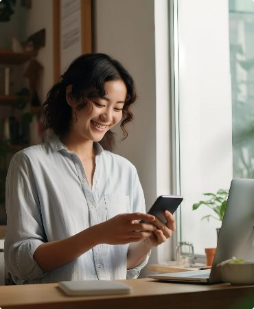 Woman smiling while looking at mobile device screen