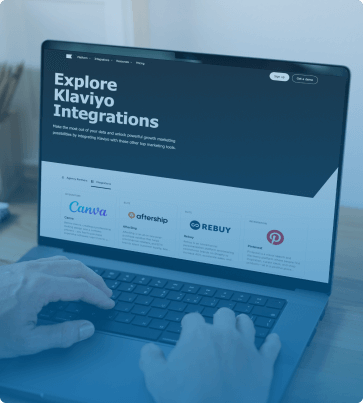 Explore Klaviyo Integrations – A person browsing Klaviyo’s integration page on a laptop, showcasing seamless connections with Canva, Rebuy, and other essential tools for eCommerce growth.