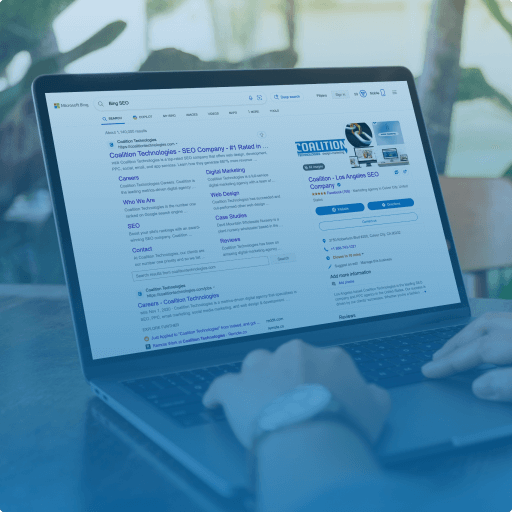 A person using a laptop to search for an SEO company, displaying search engine results on the screen