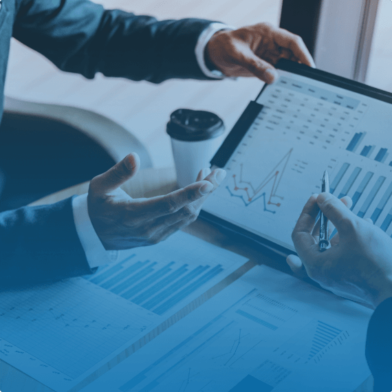 hands in front of a monitor with charts