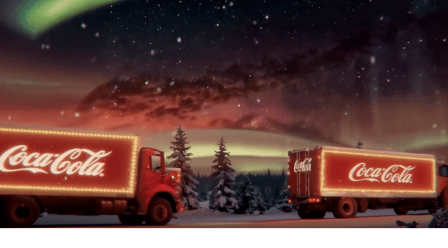 Two Coca-Cola trucks driving in the night