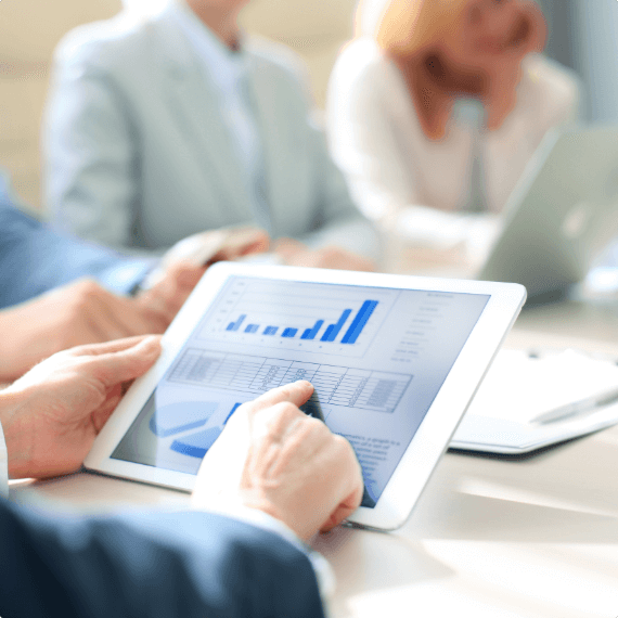 man holding a tablet with enterprise SEO analytics in front of other people