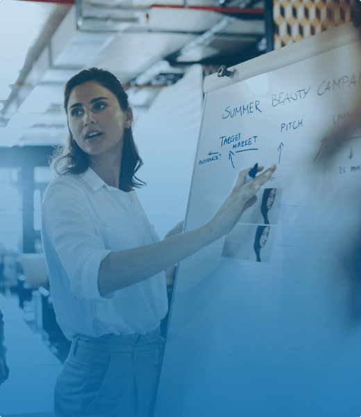 women writing on a whiteboard about a summer beauty campaign