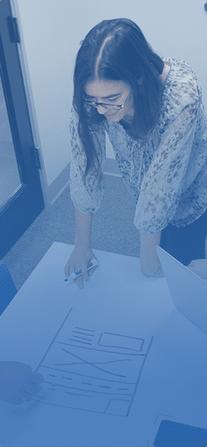 a young woman working on a chart on a white table
