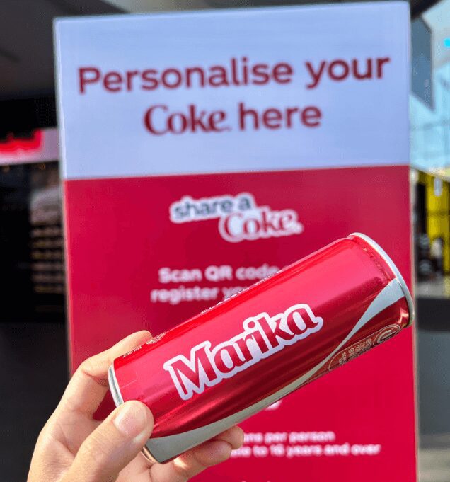 Hand holding up a Coke can that says ‘Marika’