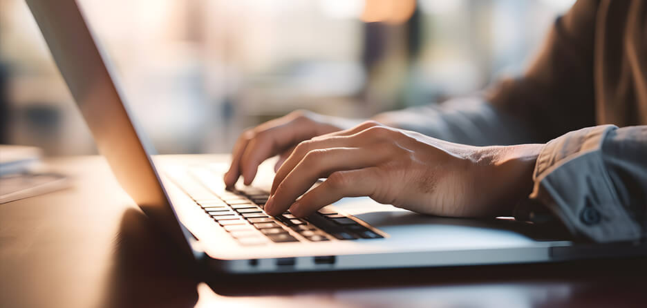 hands typing on a laptop