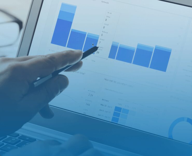 hand pointing at screen with charts