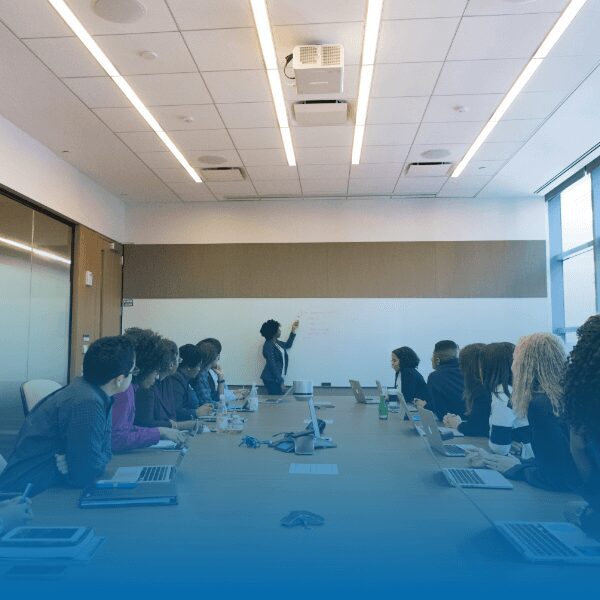 people in a conference room looking ahead