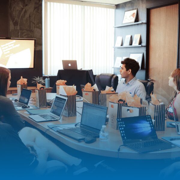 people sitting around an oval conference table