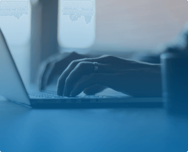 a person typing on a laptop, close-up