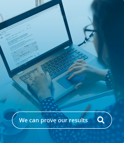 a woman with glasses doing a Google search on a laptop