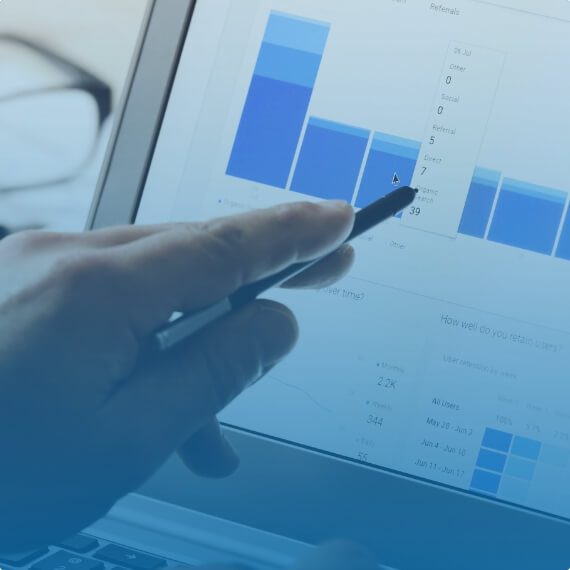 hand holding a stylus pointing to charts