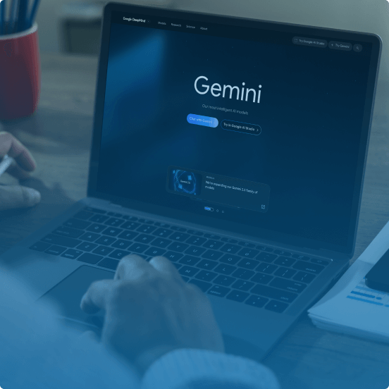 person in front of laptop displaying Gemini
