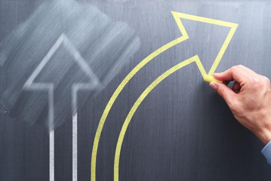 Erased white arrow and new yellow arrow being drawn on chalkboard